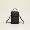 Classic black shoulder bag on a warm white studio background