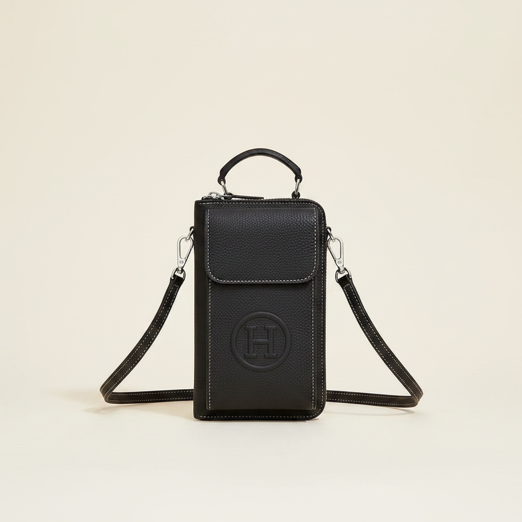 Classic black shoulder bag on a warm white studio background